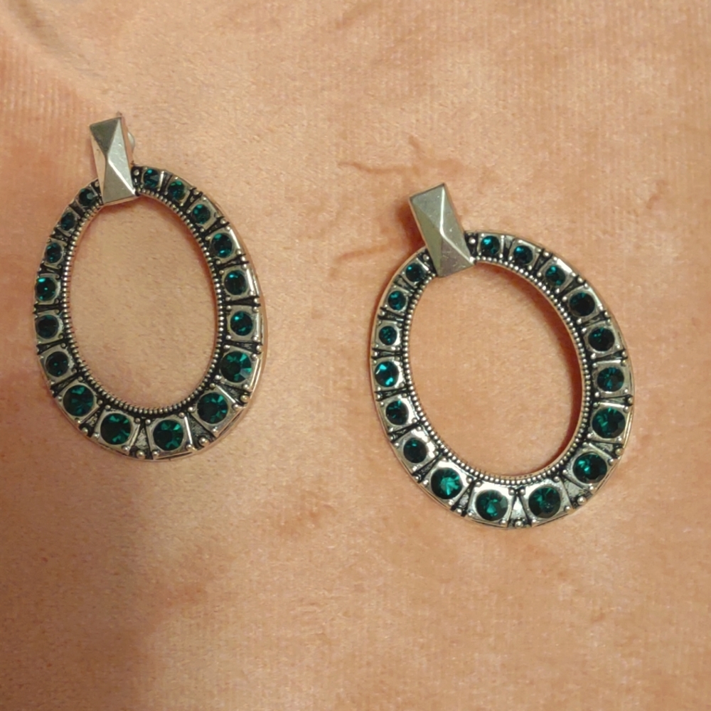 Silver hoop earrings with green stones
